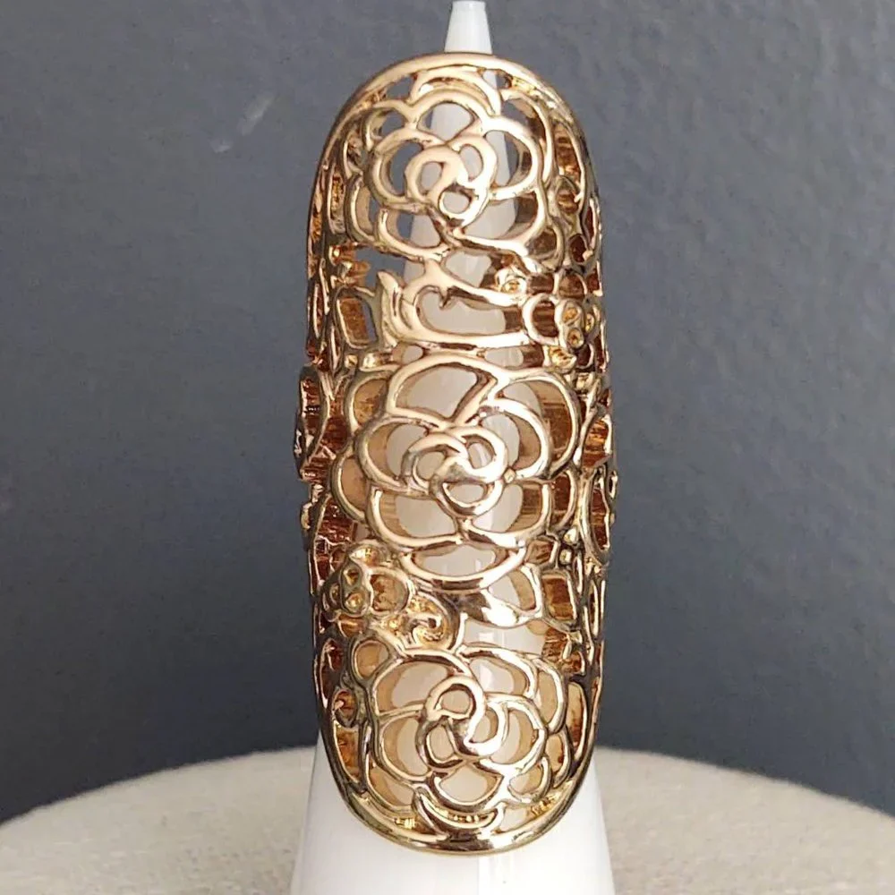 Long, open scroll design gold ring